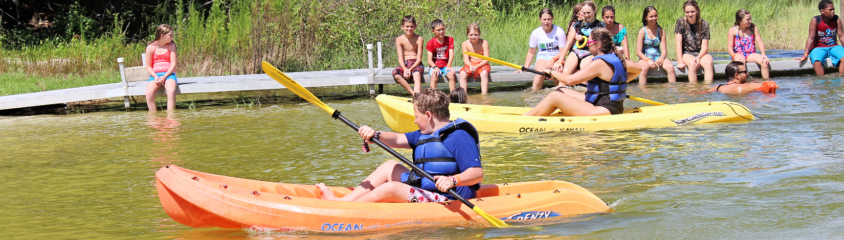 4-H youth kayaking at Camp Cloverleaf