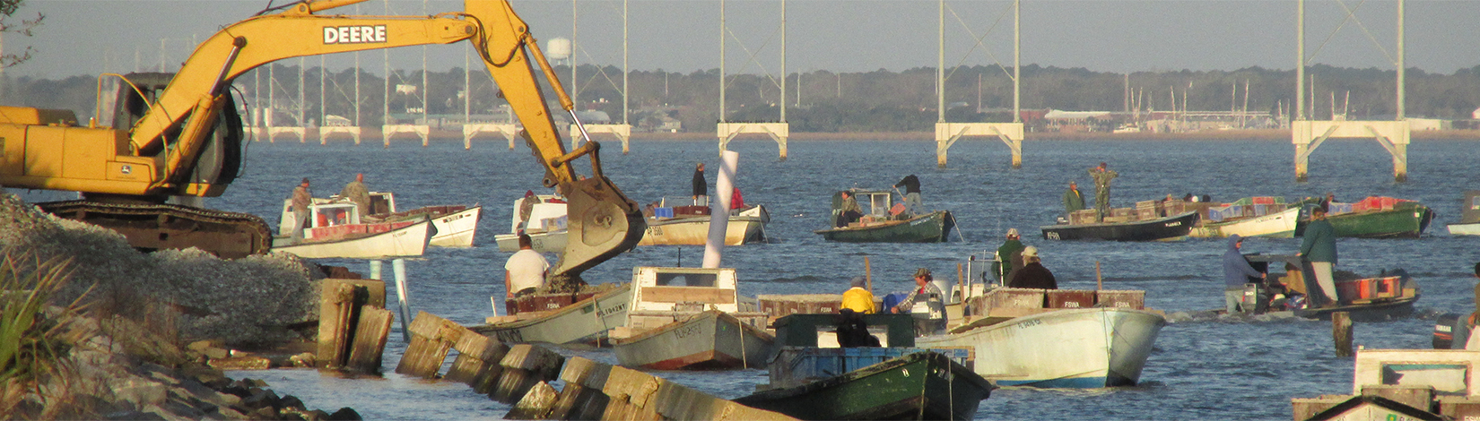 Crane with oyster boats 