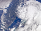 satellite image of a large tropical storm approaching Florida through the Atlantic Ocean