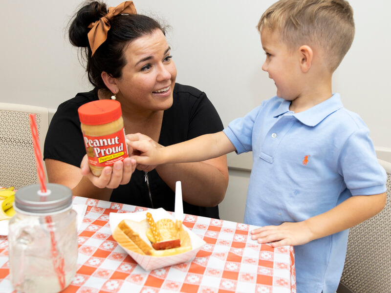 woman with little boy and peanut butter