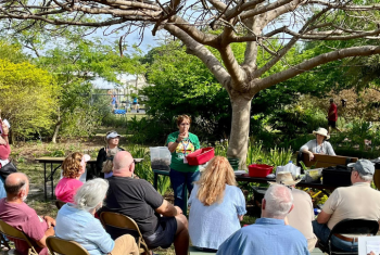 Image of attendees at an education event in a garden