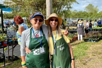 Two master gardener volunteers posing for a photo