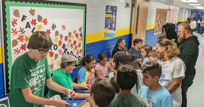 Members of the Duval 4-H STEAM Club demonstrating mini robots in a local elementary school.