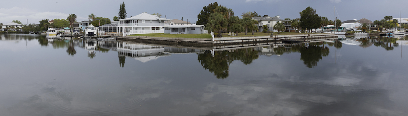 Panoramic view of houses on a waterway.