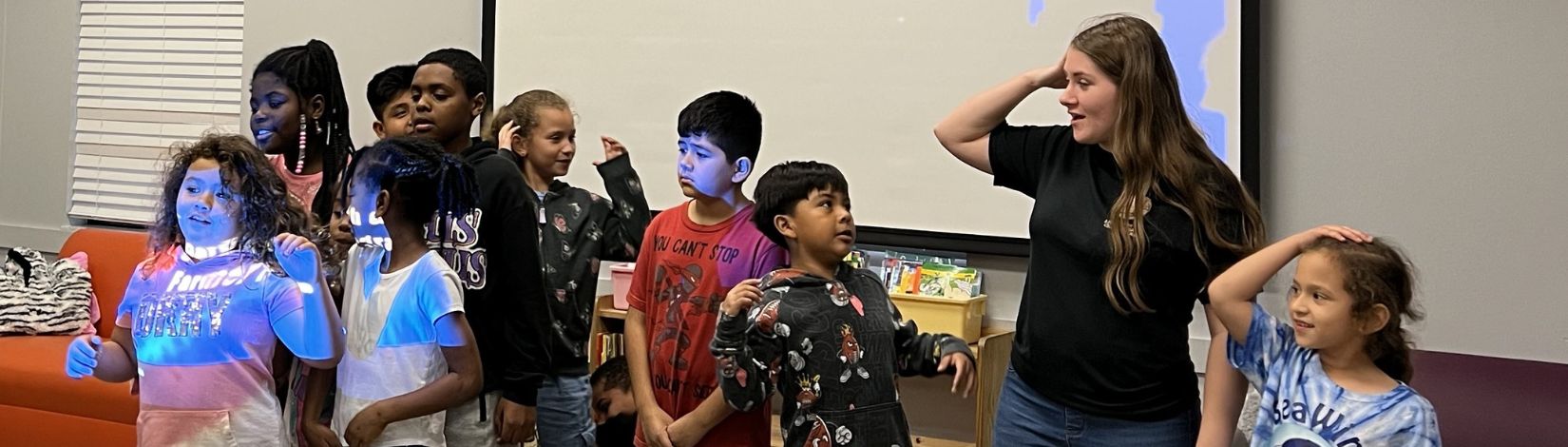 youth performing the 4-H Pledge with the 4-H Program Assistant