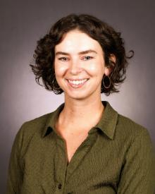 Florida Friendly Extension Agent Heather Kalaman wearing a green shirt against a grey background
