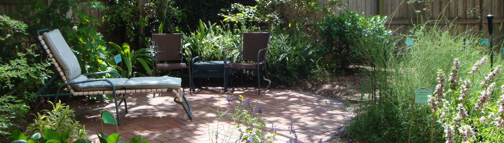 landscaped patio with chairs