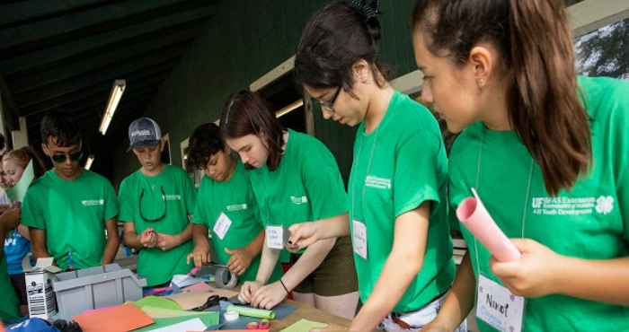 Youth standing at table doing crafts