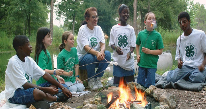 4-H Youth sitting around a campfire