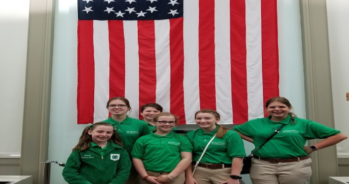 4-H Youth at the Capitol standing in front of American Flag