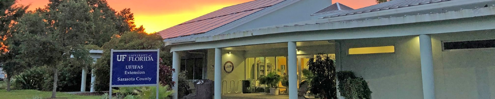 exterior shot of UF/IFAS Extension Sarasota County office at sunset, with orange-red sky in background