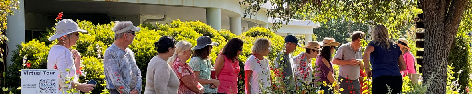 a master gardener volunteer (blue shirt) with uf/ifas extension sarasota county leads a group tour of demonstration gardens at the extension office. [credit: uf/ifas extension sarasota county]