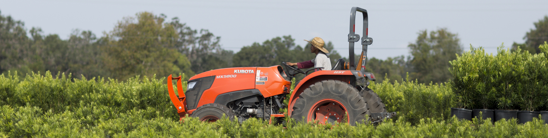 worker on tractor in ag field