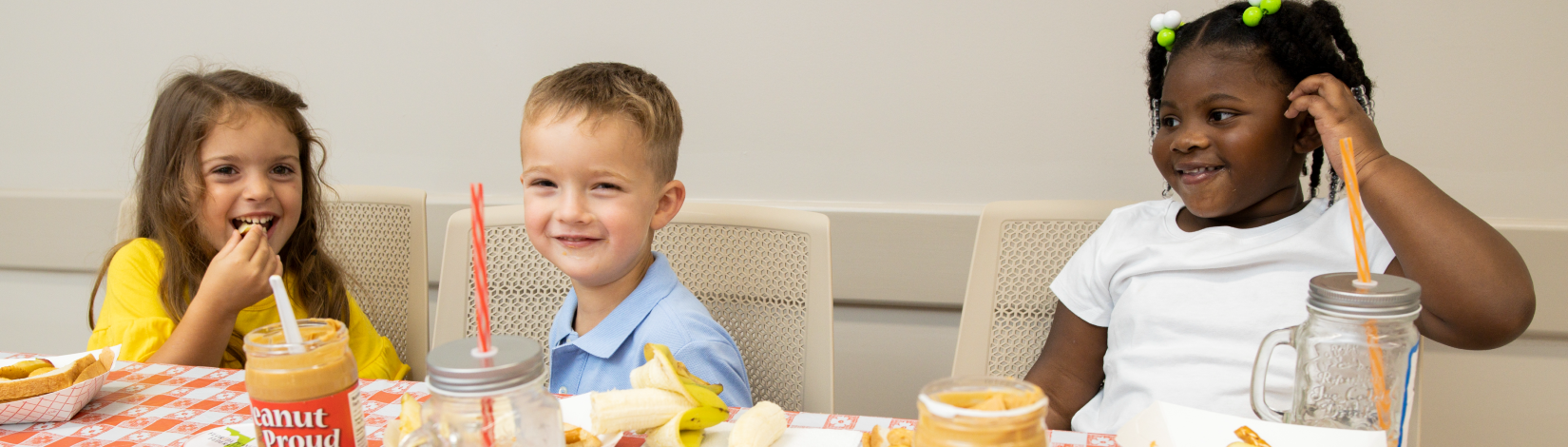 Children enjoy healthy snacks of banana slices and peanut butter treats