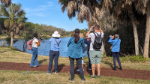 staff and students use binoculars to view birds and other wildlife on an 