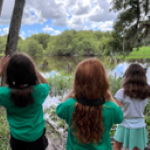 young girls use binoculars to scan for distant animal and plant life. [credit: uf/ifas extension sarasota county]