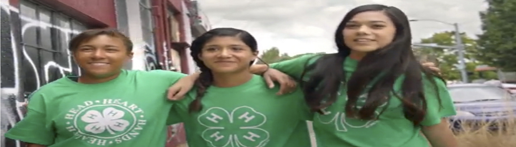 3 girls wearing green 4-H t-shirts