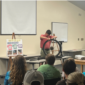 Student with bicycle tire