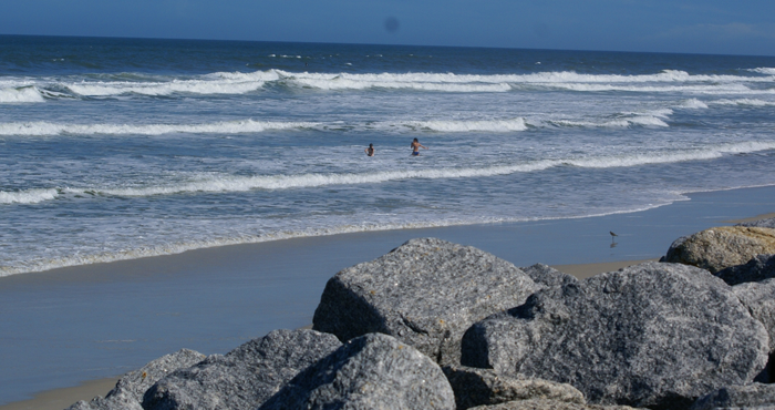 Waves breaking on Marineland Beach with large rocks in the foreground.